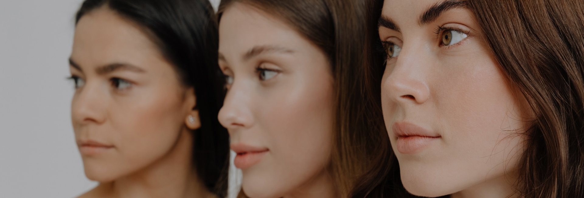 Side profiles of three women showcasing natural nasal aesthetics, representing different rhinoplasty considerations.