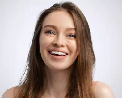 Happy young woman after Lip Augmentation performed by Dr. Bustillo in Miami.