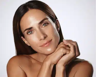 Happy woman after Under Eye Filler procedure in Miami.