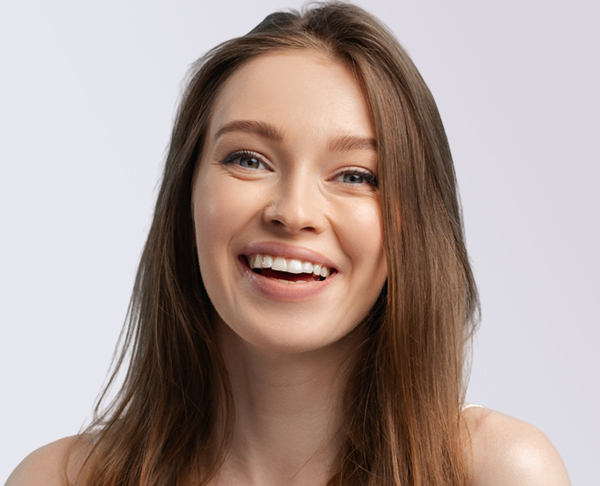 Happy young woman after Lip Augmentation performed by Dr. Bustillo in Miami.