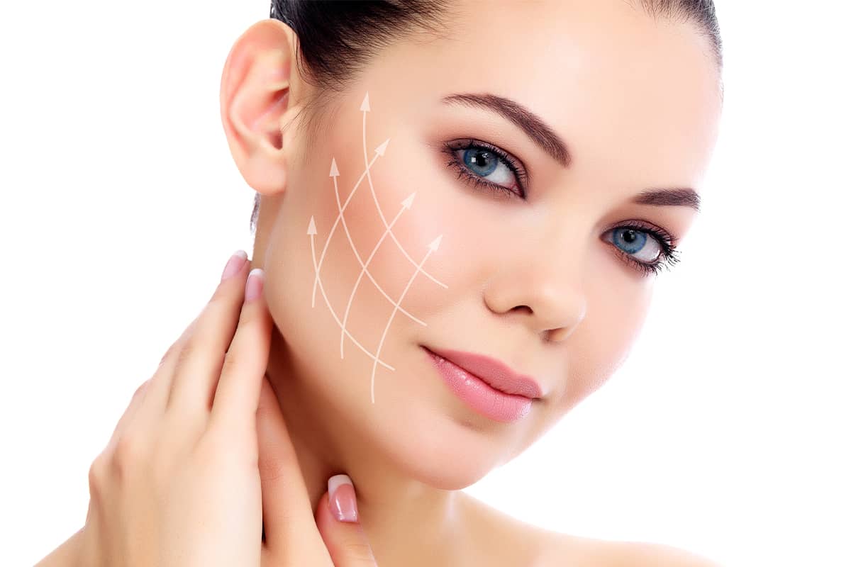 A close-up profile view of a young woman with blue eyes against a white background, with white vector arrows and grid lines overlaid on her cheek.